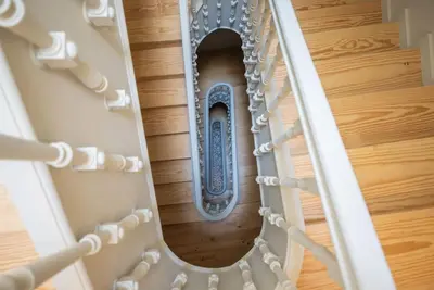 a spiral staircase with a mirror in a house at Truly Porto in Porto