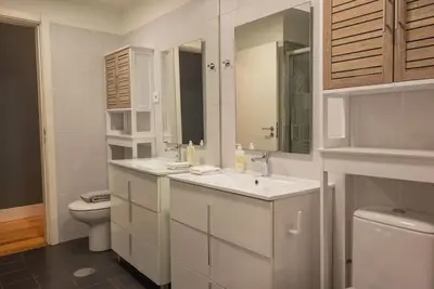 a white bathroom with a toilet and a sink at So Truly Porto in Porto