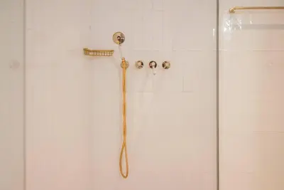 a shower with a shower head in a bathroom at Gracy Porto in Porto