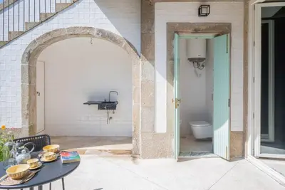 an outdoor patio with a table and a toilet at Gracy Porto in Porto