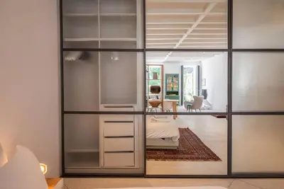 a room with sliding glass doors and a bedroom at Gracy Porto in Porto