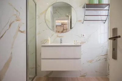 a bathroom with a sink and a mirror at Mercadory Ribeira in Porto