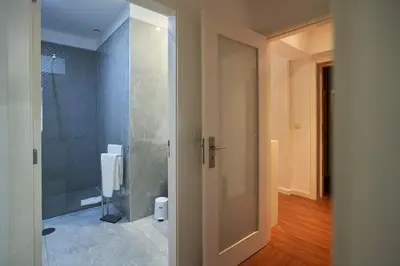 a bathroom with a shower and a glass door at So Family Porto in Porto