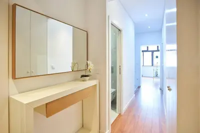 a bathroom with a sink and a mirror at So Family Porto in Porto