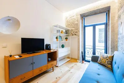a white bedroom with a bed and a balcony at Netto City Vibes in Porto