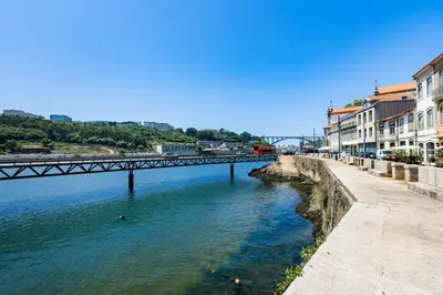 a living room with a couch and a tv at Porto City Holidays by Douro River in Porto