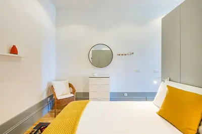 a hallway with a bed and a door to a bedroom at Boavista Prime Studio in Porto