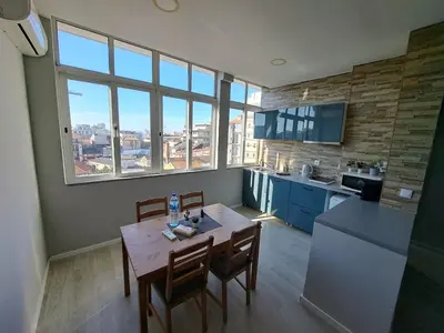 a kitchen with a table and chairs in a room at Bolhão Apartment in Porto