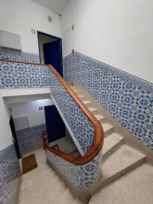 a staircase with blue and white tiled walls at Bolhão Apartment in Porto