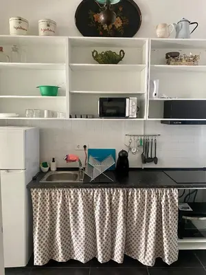 a kitchen with a sink and a counter top at Estúdio Histórico século XIX com Varanda e Vistas para a Baixa in Porto