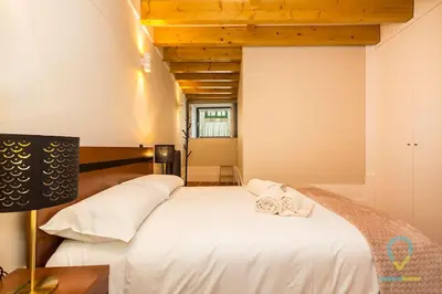 a bedroom with a white bed with two towels on it at Trendy Porto in Porto