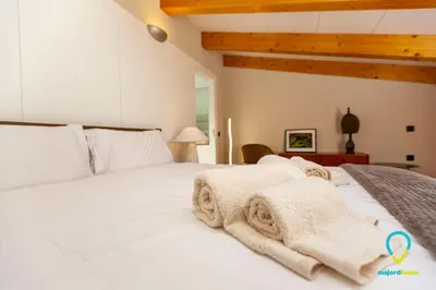 a bedroom with a white bed with towels on it at So Trendy Porto in Porto