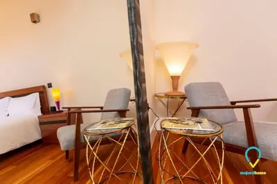 a bedroom with two chairs and a bed and a lamp at So Trendy Porto in Porto