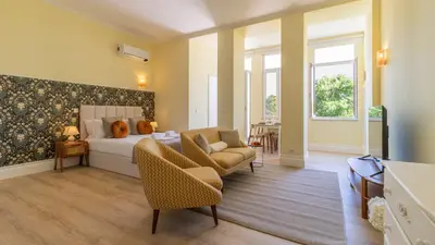 a living room with a bed and a couch at Urban House Marquês by LovelyStay in Porto