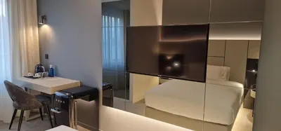 a hotel room with a white bed and a desk at Bom Sucesso Hotel by gaiarooms in Porto