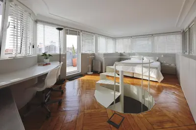 a living room with a table and a bed at Boavista Sunlit Duplex with Terrace in Porto