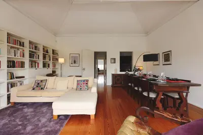 a living room with a white couch and a desk at Boavista Sunlit Duplex with Terrace in Porto