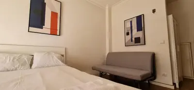 a bedroom with a bed and a chair at Constituição 1012 in Porto