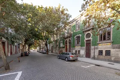 a car parked on the side of a street with buildings at Downtown Grand Houses in Porto