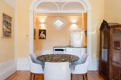 a dining room with a table and chairs at Downtown Grand Houses in Porto