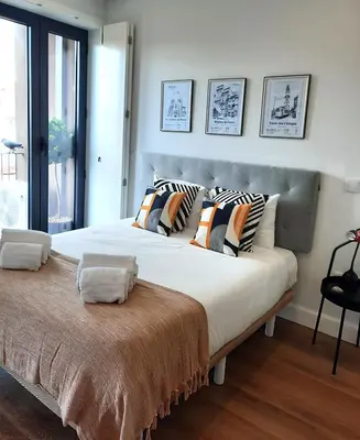 a large bed with pillows on it in a bedroom at Smiling Places - Apartment in Porto in Porto