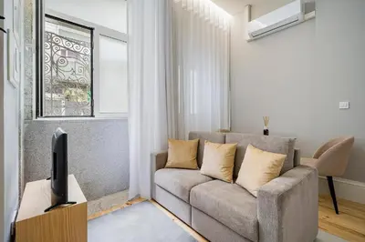a living room with a couch and a tv at GuestReady - Comendador Sto Ildefonso in Porto