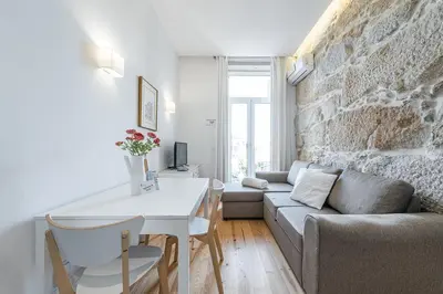 a living room with a couch and a table at GuestReady - Comendador Sto Ildefonso in Porto
