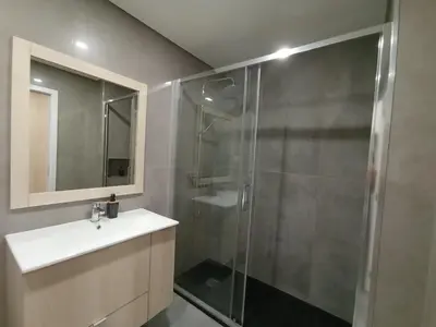 a bathroom with a shower and a sink and a mirror at 714 Galé Apartment Wi-Fi in Porto