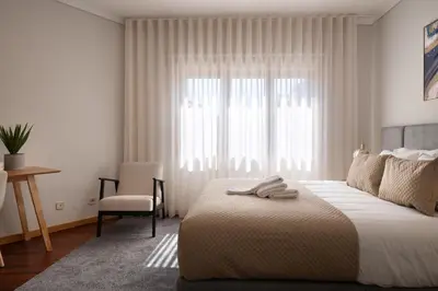 a living room with a couch and a chair at Home Essences in Porto