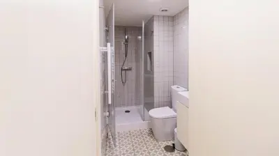 a bathroom with a shower and a toilet and a sink at Boavista Loft by LovelyStay in Porto