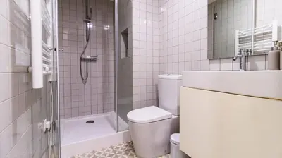 a white bathroom with a toilet and a shower at Boavista Loft by LovelyStay in Porto