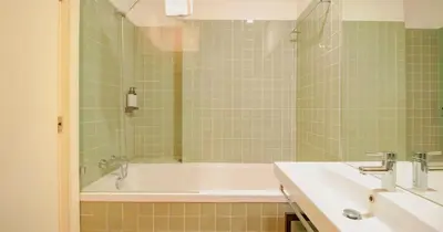 a bathroom with a tub and a sink at ALIADOS by YoursPorto in Porto