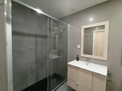 a bathroom with a shower and a sink and a mirror at 715 Galé Apartment Wi-Fi, Estacionamento in Porto