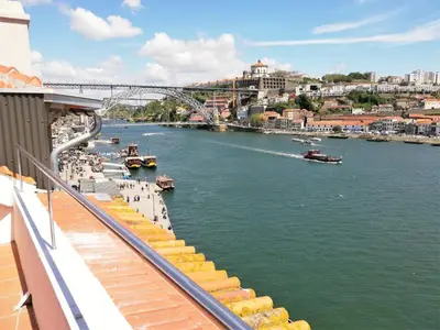 a view of a river with boats in the water at RIBEIRA by YoursPorto in Porto