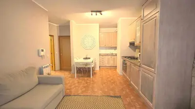 a small living room with a couch and a kitchen at RIBEIRA by YoursPorto in Porto