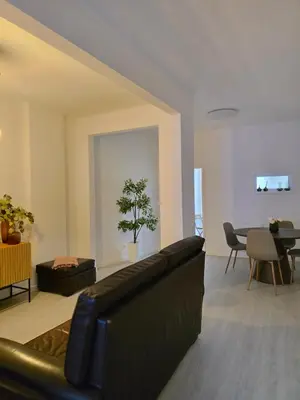 a living room with a black couch and a table at River Flat III - Heart of Porto in Porto