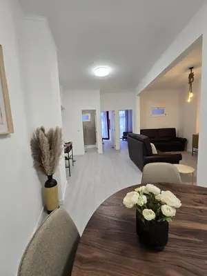 a living room with a table with flowers on it at River Flat III - Heart of Porto in Porto