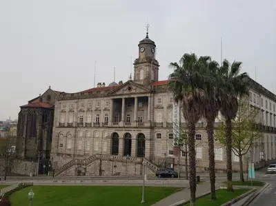 an old building with a clock tower on top of it at River Flat III - Heart of Porto in Porto