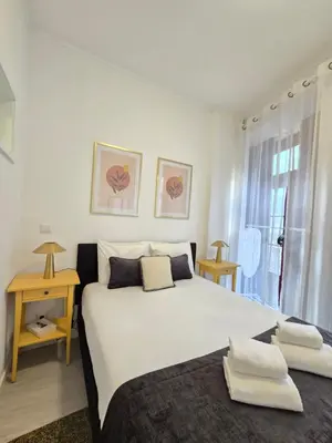 a bedroom with a large white bed and a window at River Flat III - Heart of Porto in Porto