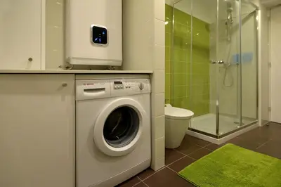 a washing machine in a bathroom with a shower at Welcome to my city in Porto