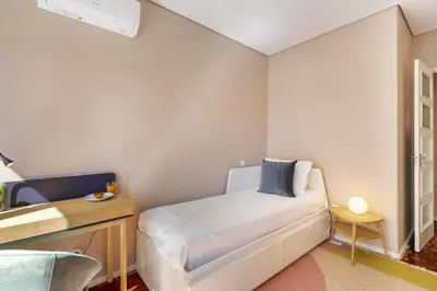 a small bedroom with a bed and a desk at WHome SC996 in Top Location 3-Bed Perfect to explore Porto in Porto
