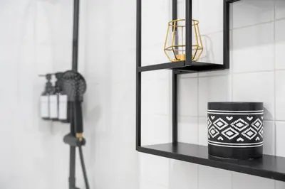 a black shelf with a candle and a camera at Porto Calm Terrace Apartment in Porto