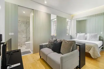 a bedroom with a bed and a couch and a television at WHome Timeless Luxury Porto w/ AC & Elevator in Porto