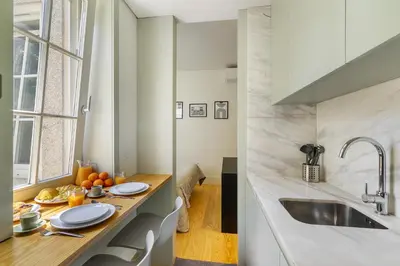 a kitchen with a dining table and a sink at WHome Timeless Luxury Porto w/ AC & Elevator in Porto