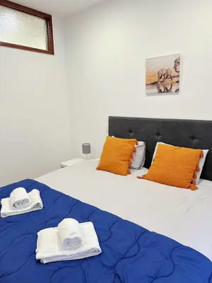 a bedroom with two beds with towels on them at Downtown 2 minutes by walk to center and metro-direct to airpot T4 in Porto