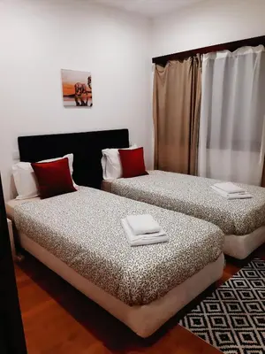 two beds sitting next to each other in a room at Downtown 2 minutes by walk to center and metro-direct to airpot T4 in Porto