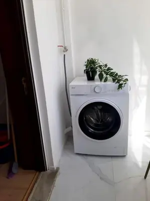 a washing machine with a plant on top of it at Downtown 2 minutes by walk to center and metro-direct to airpot T4 in Porto