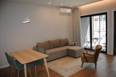 a living room with a couch and a table and chairs at Gaia Loves You - Serra do Pilar in Vila Nova de Gaia