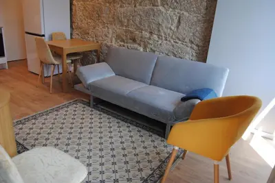 a living room with a blue couch and a table at Gaia Loves You - Jardim do Morro in Vila Nova de Gaia