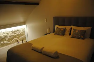 a bedroom with a large bed with a window at Gaia Loves You - Jardim do Morro in Vila Nova de Gaia